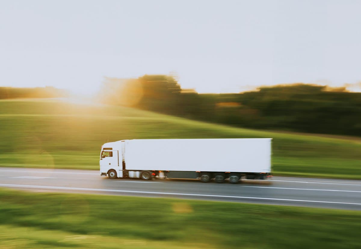 A white articulated lorry on the open road